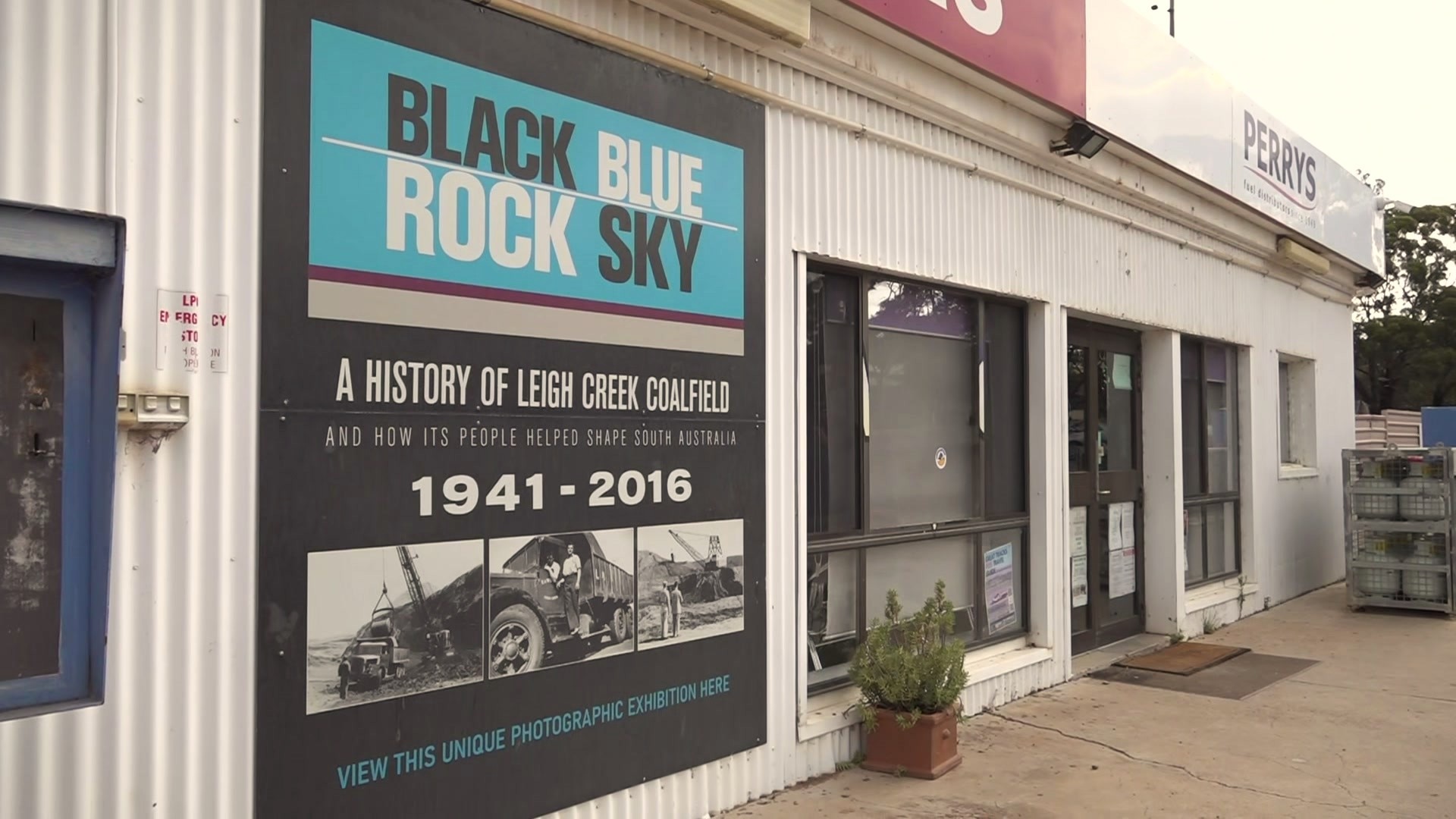 The exterior of a building with signage saying 'black rock blue sky'.