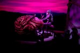 Lady Gaga plays a piano the looks like a giant human brain during the MTV Video Music Awards