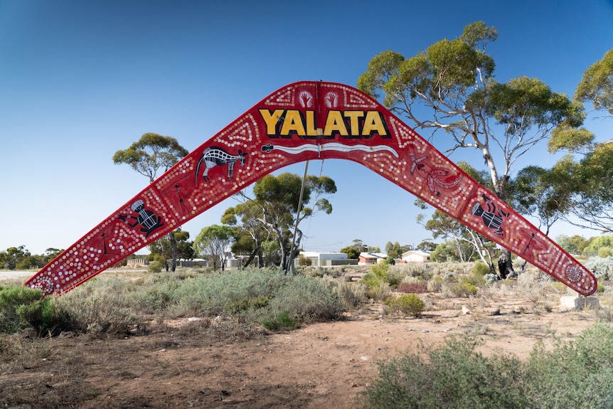 A large sign in the shape of a boomerang with Yalata written on it 