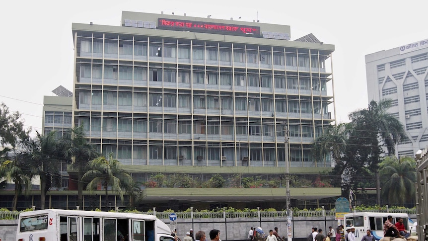 Commuters pass the central bank building in Bangladesh