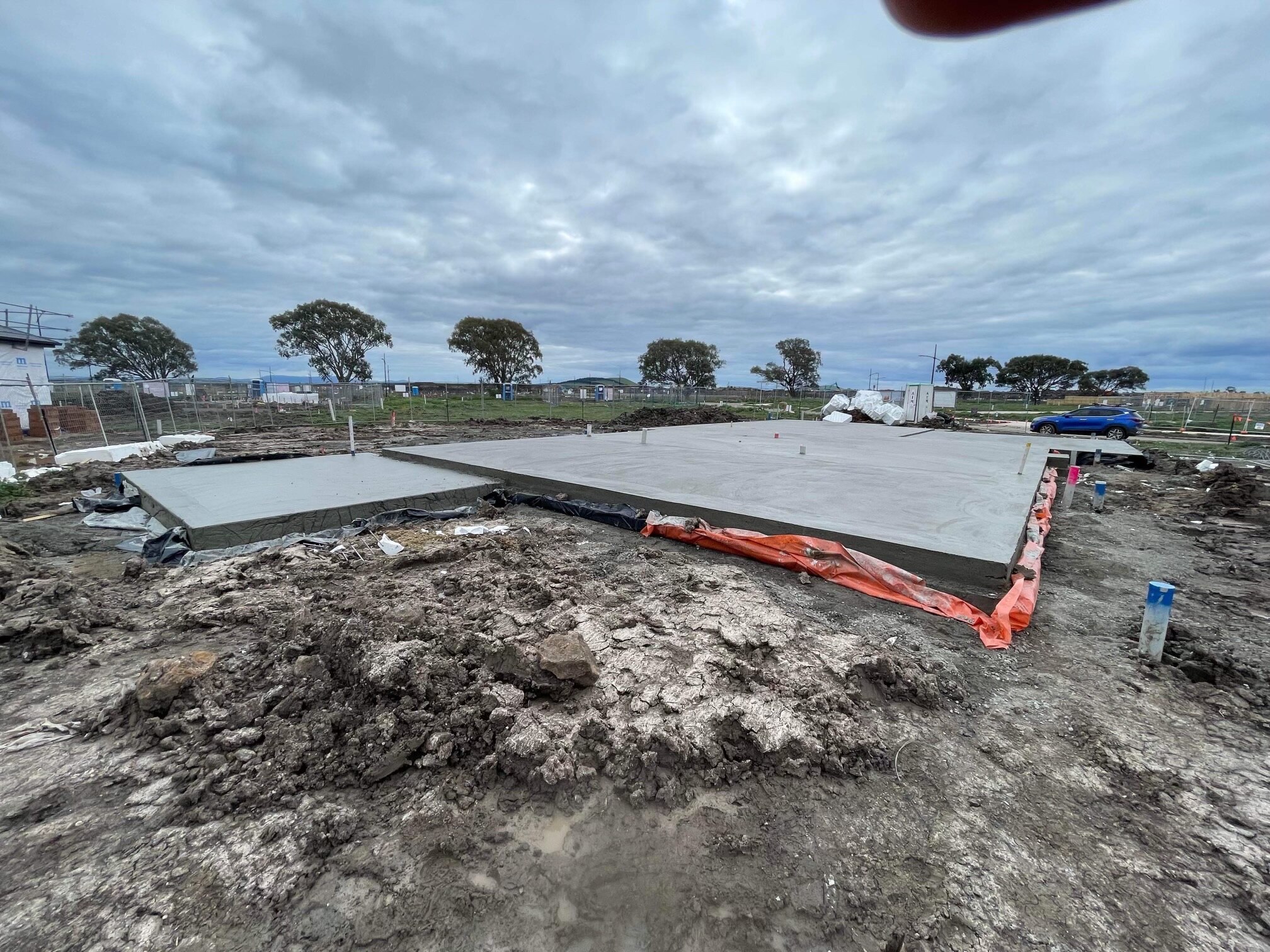 A large concrete slab in a field of construction 
