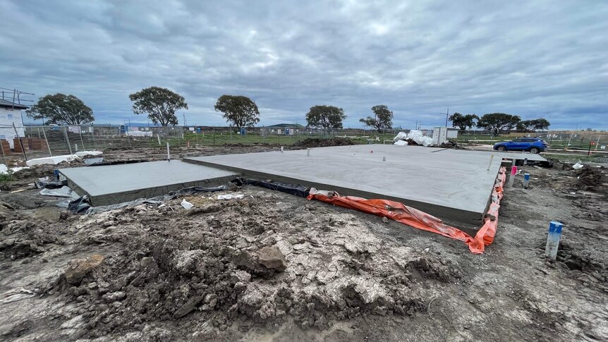 A large concrete slab in a field of construction 