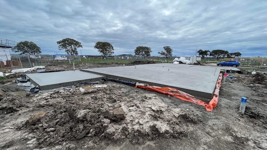 A large concrete slab in a field of construction 