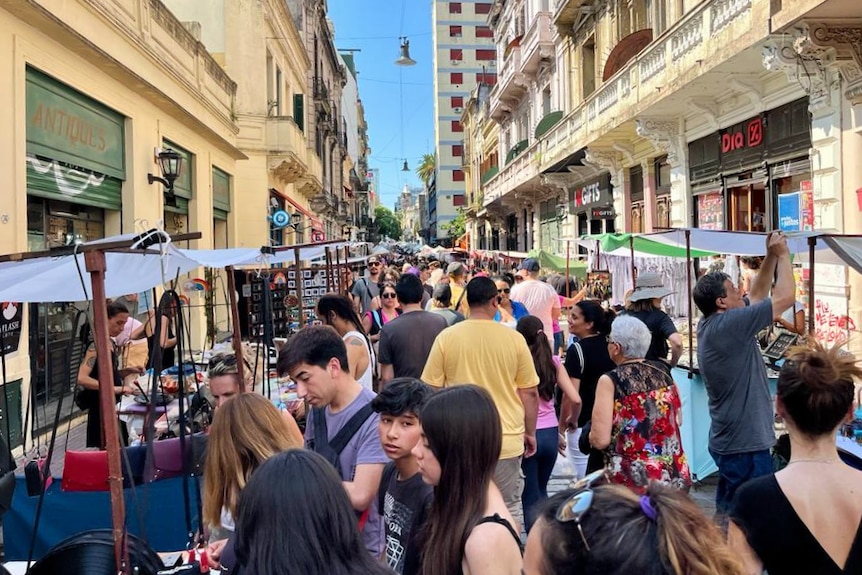 Crowds of people in an outdoor market.