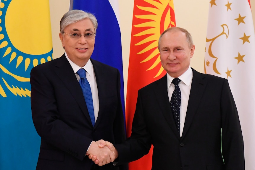 Russian President Vladimir Putin, right, shakes hands with Kazakhstan President Kassym-Jomart Tokayev.