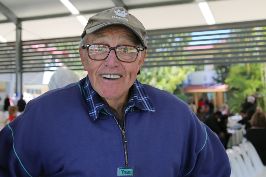 Man standing with hands on hips smiling