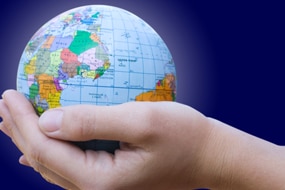 Hands support a miniature globe (Thinkstock: Getty Images)