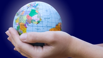 Hands support a miniature globe (Thinkstock: Getty Images)