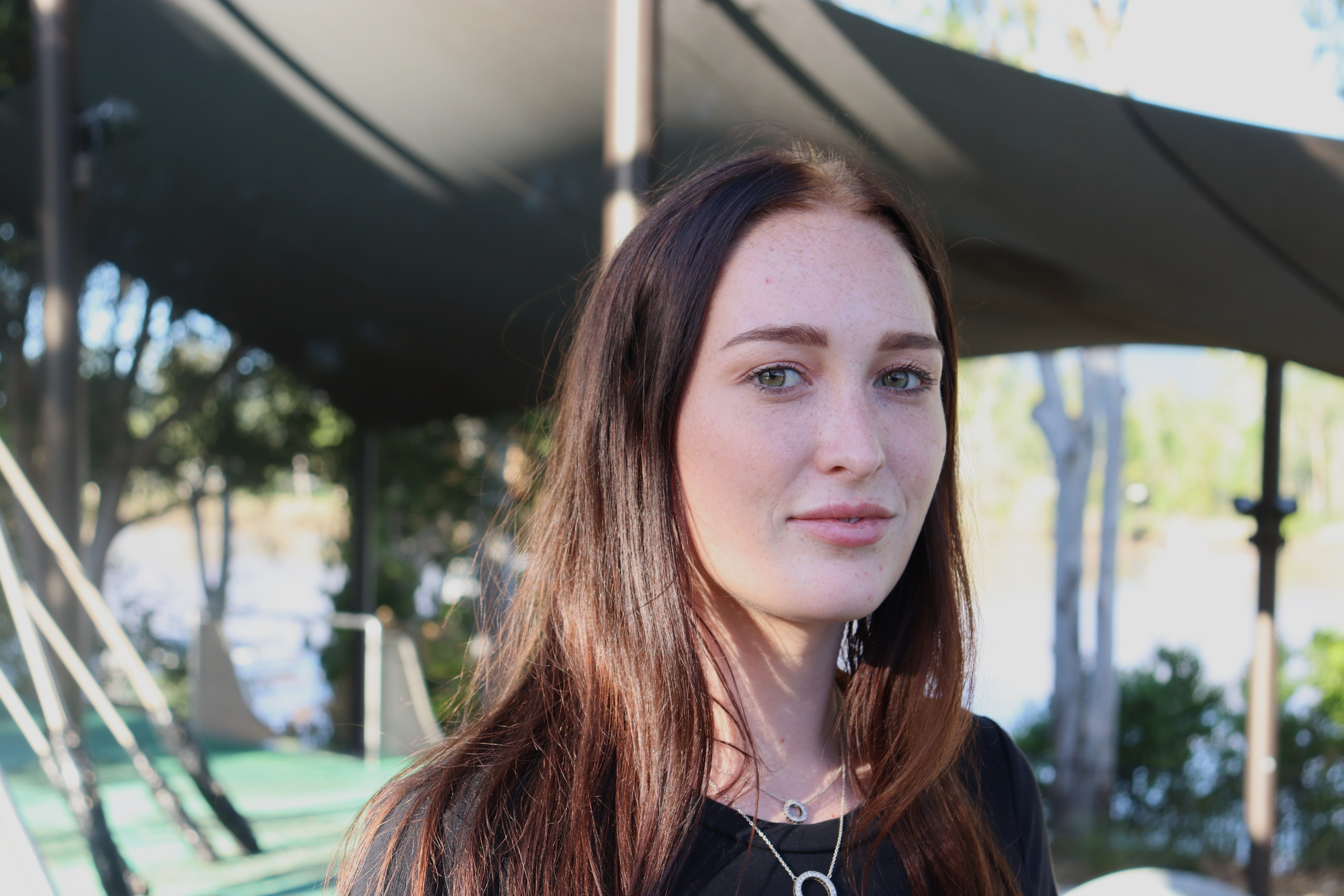 Woman looks at camera with neutral expression