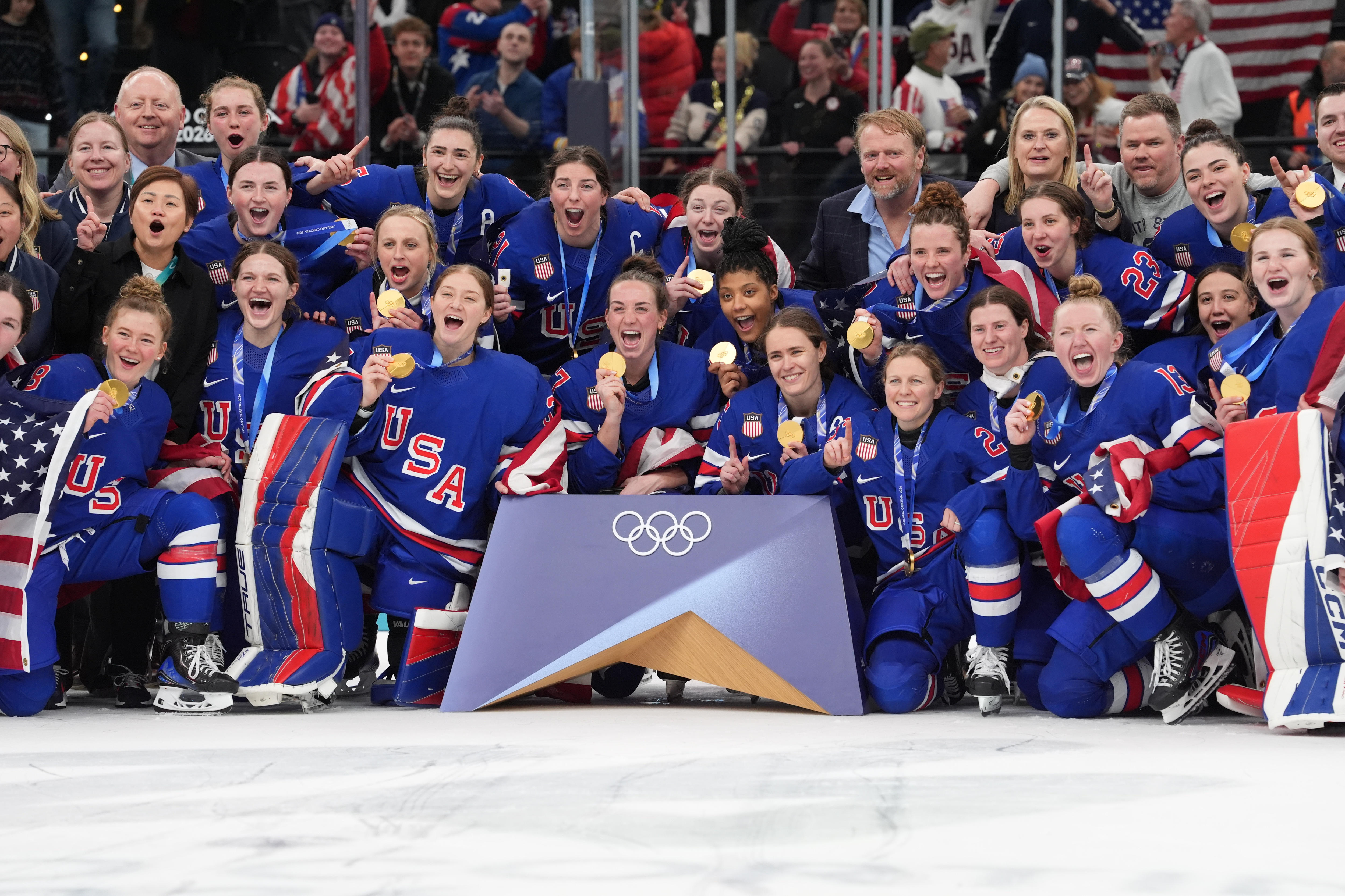United States players celebrate with their gold medals after defeating Canada in the women's ice hockey