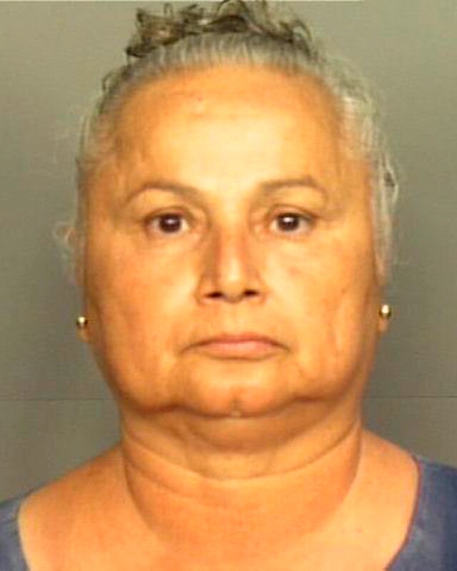 A mug shot of a Latina woman in her late 60s/early 70s