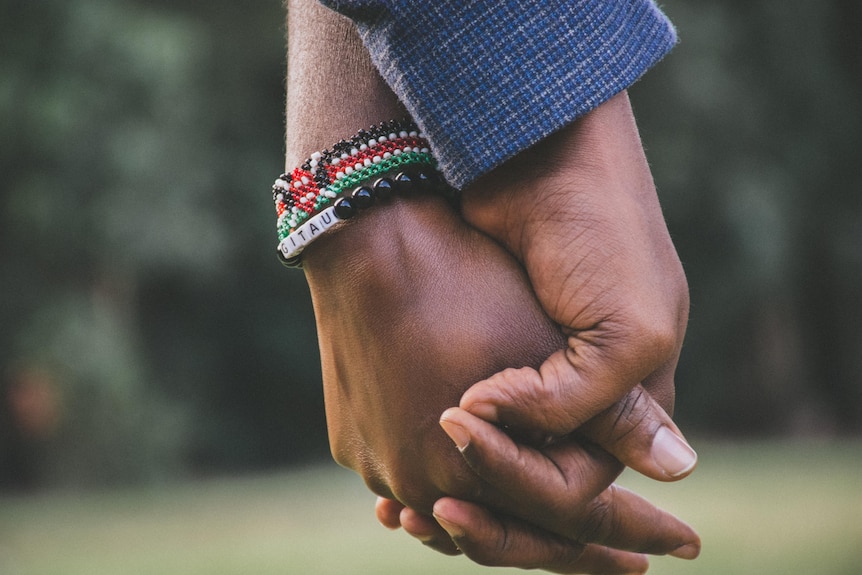 A couple holding hands.