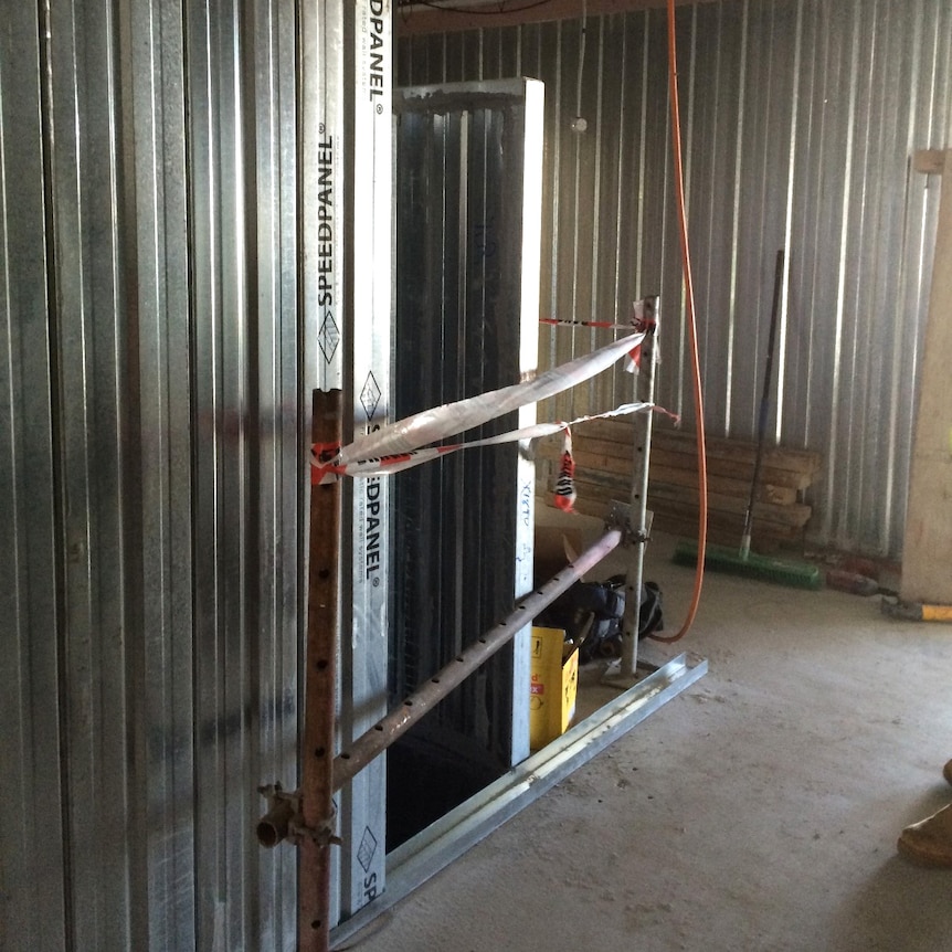 A ventilation shaft at an East Perth apartment site guarded by tape and a metal bar.