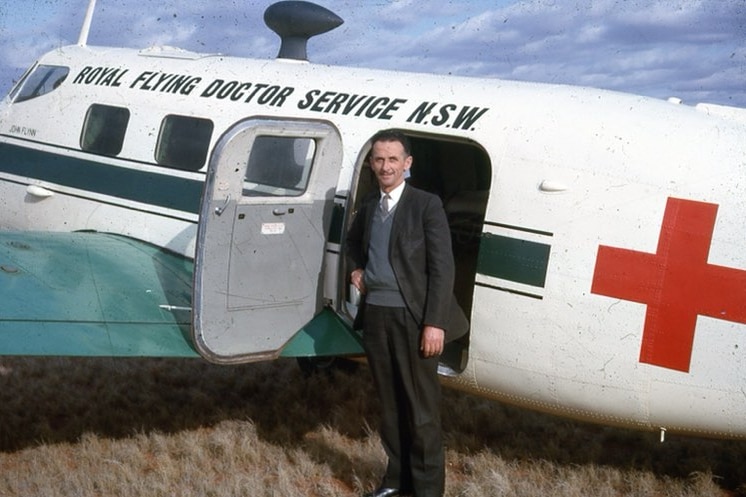 A man stands at the door of a Royal Flying Doctor Service plane in the early 1960s.