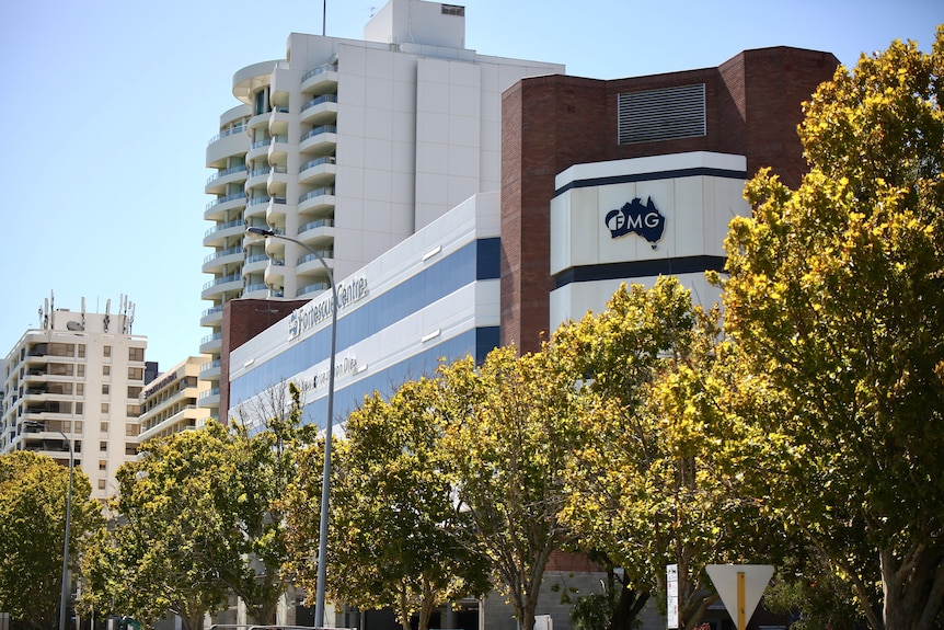 A blue and white sign with the initials 'FMG' on it. 