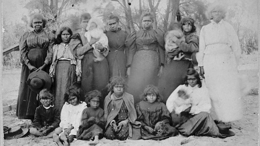 Old photo of Aboriginal women and children in European dress