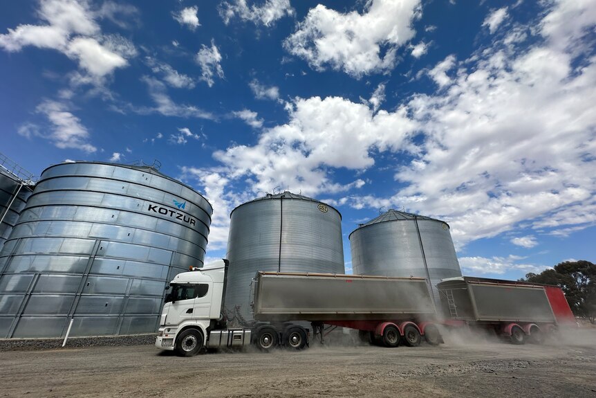 a truck near grain silos