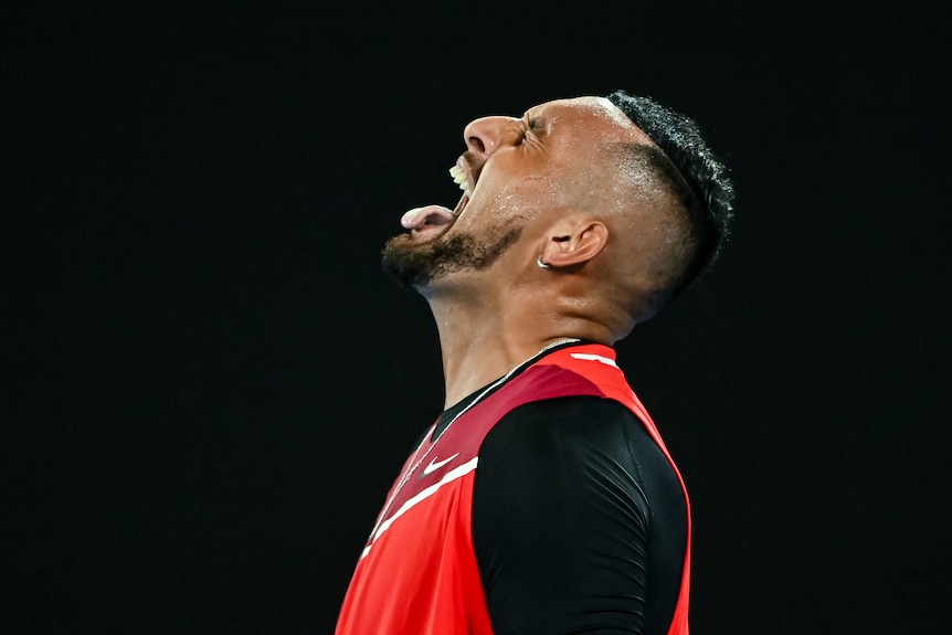 Australian tennis player Nick Kyrgios sticking his tongue out in celebration after winning a point again Daniil Medvedev