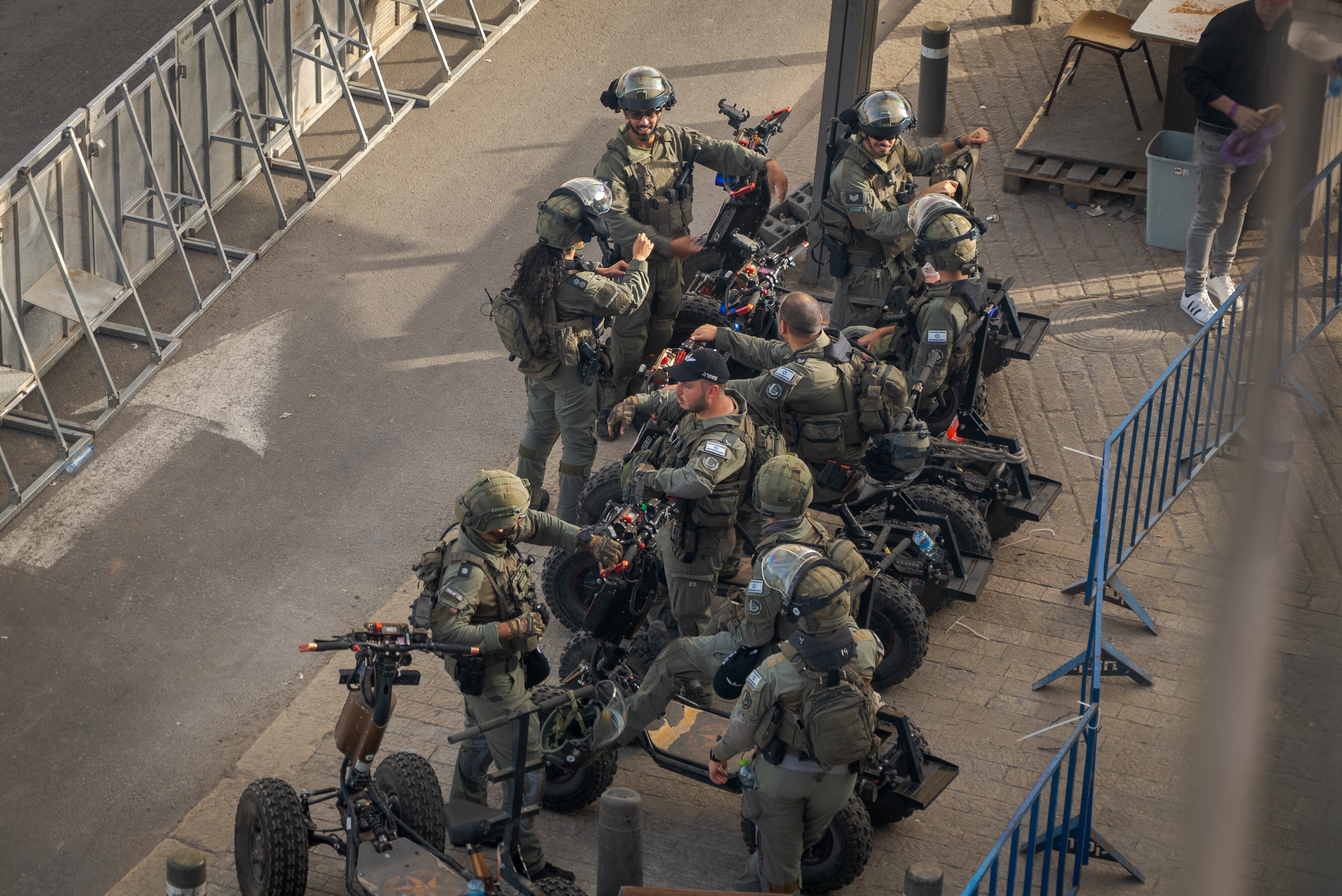 Israeli troops cluster on a road 