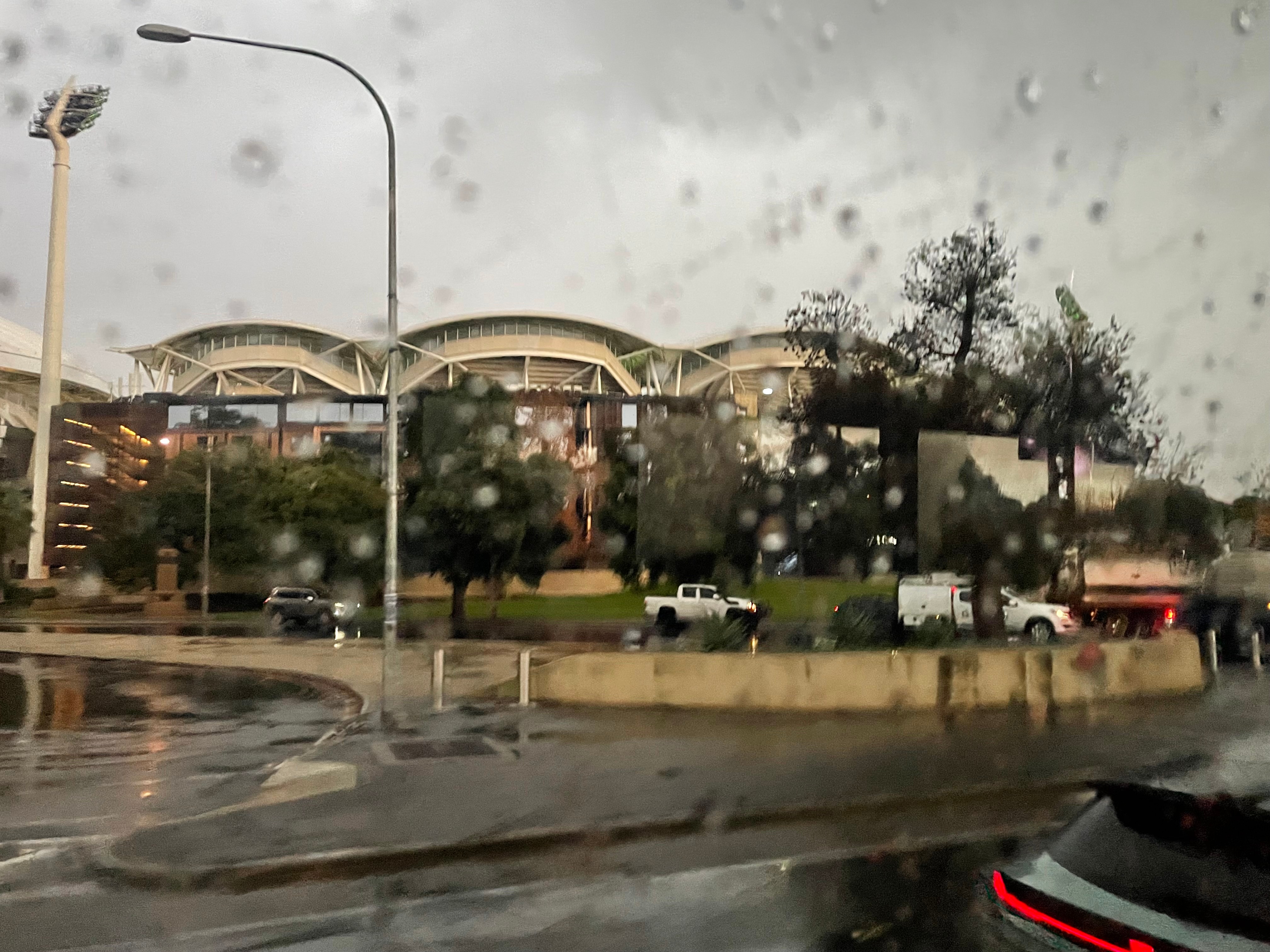 A stadium during rainy weather with drops on a window