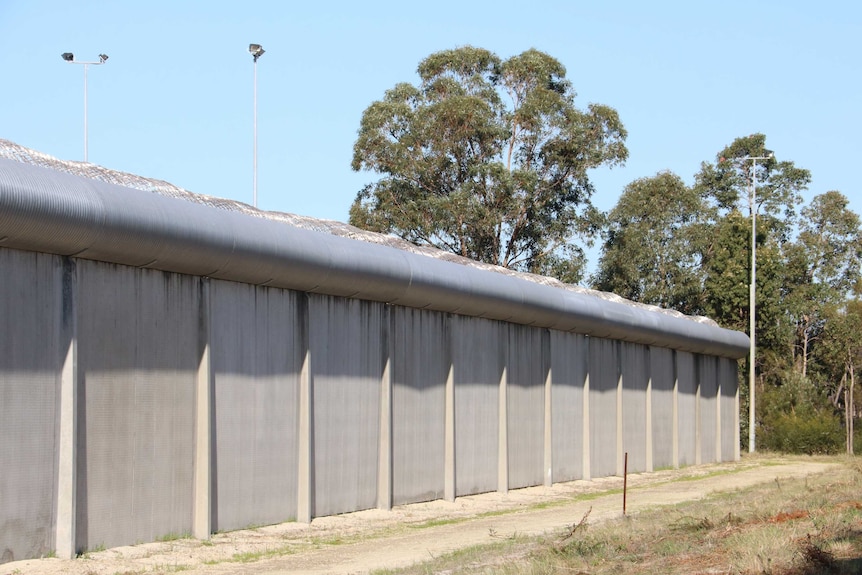 A concrete wall topped with barbed wire at the Banksia Hill Detention Centre.