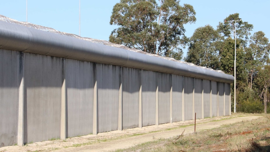 A concrete wall topped with barbed wire at the Banksia Hill Detention Centre.