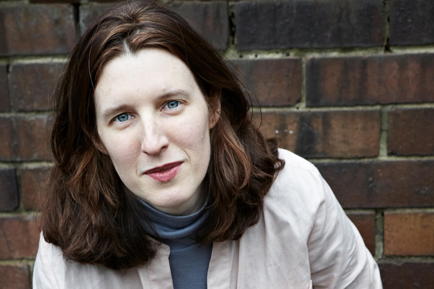 Author Chloe Hooper wearing blue turtleneck, and light-pink shirt.