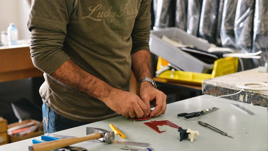 Man in a workshop working with his hands for a story about finding a career that matches your personality.