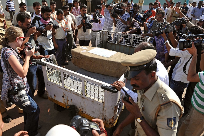 Media gather around the coffin of Jacintha Saldanha after it arrived in India.