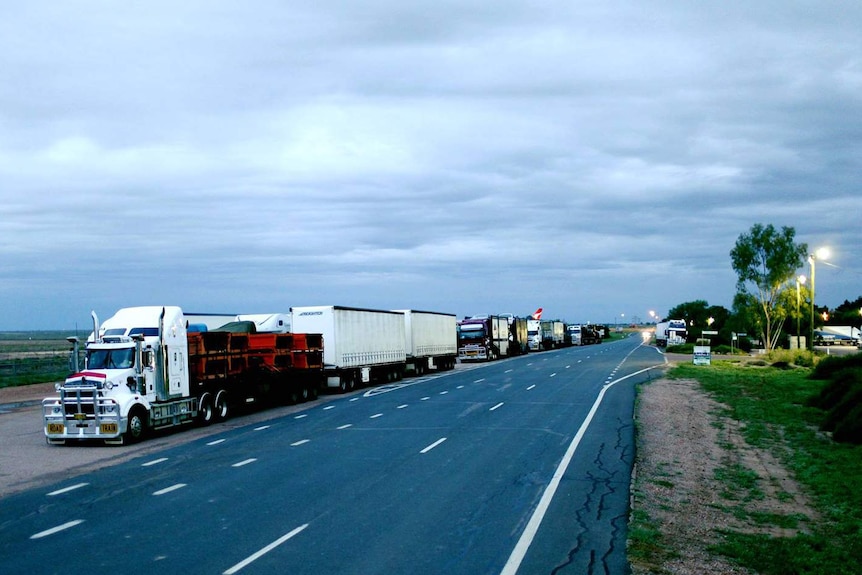 A line of trucks parked on side of road at Longreach in central-west Queensland