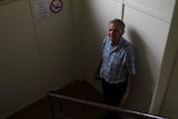 Historian Tom Sawyer standing in the stairwell of the historic Burnett House