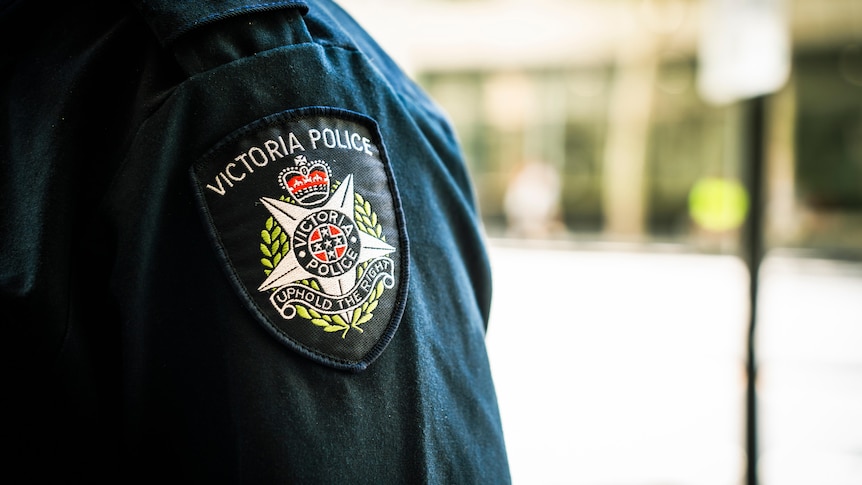 A blue sleeve with a Victoria Police badge sewn into it, including the motto "Uphold the Right".