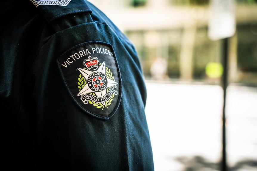 A blue sleeve with a Victoria Police badge sewn into it, including the motto "Uphold the Right".