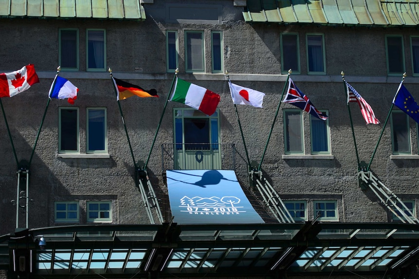 A building is seen with the flags of the G7 nations.