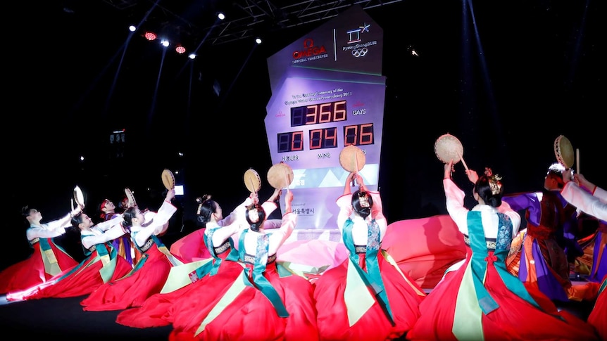 Women wearing Korean traditional costume Hanbok perform during an unveiling ceremony of the Olympic countdown clock