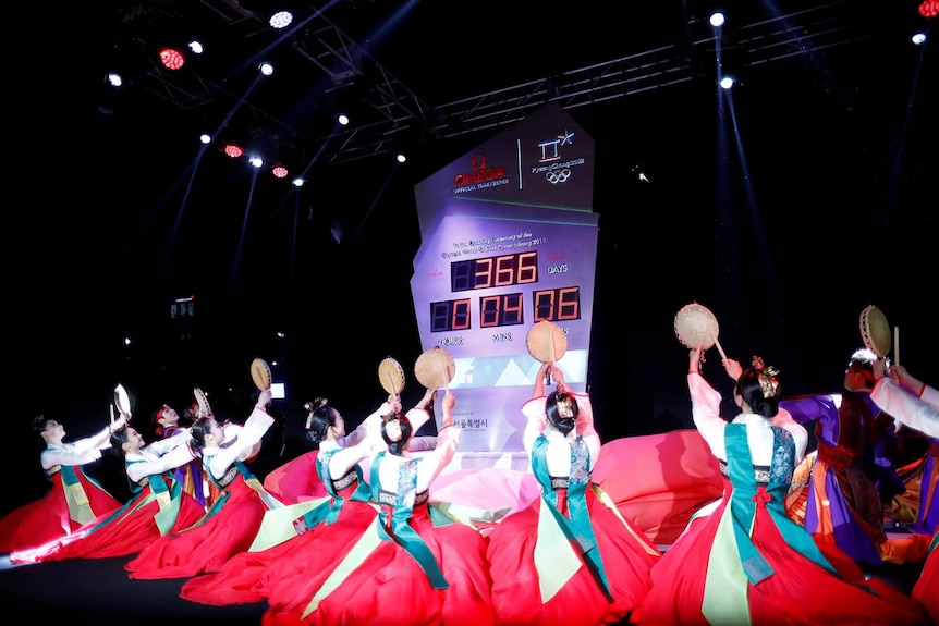 Women wearing Korean traditional costume Hanbok perform during an unveiling ceremony of the Olympic countdown clock