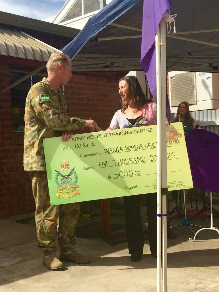 Colonel Steve Jobson, presents a cheque at the Wagga Wagga Women's Health Centre opening on March 10, 2016.