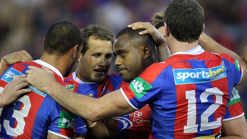 Knights winger Akuila Uate celebrates a try with team-mates