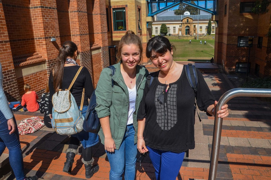 Mentor Emma Tulich and Uni 2 Beyond participant Nalyn Sirivivatnanon walk between buildings at Sydney Uni