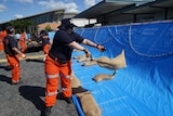 SES volunteers lay sandbags at Rockhampton Airport