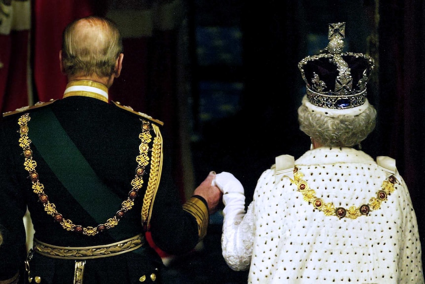 The hand of Queen Elizabeth II is held by her husband, Prince Philip, Duke of Edinburgh.
