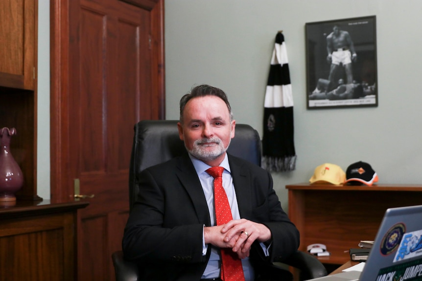 Labor leader David O'Byrne sits behind the desk in his new office. 