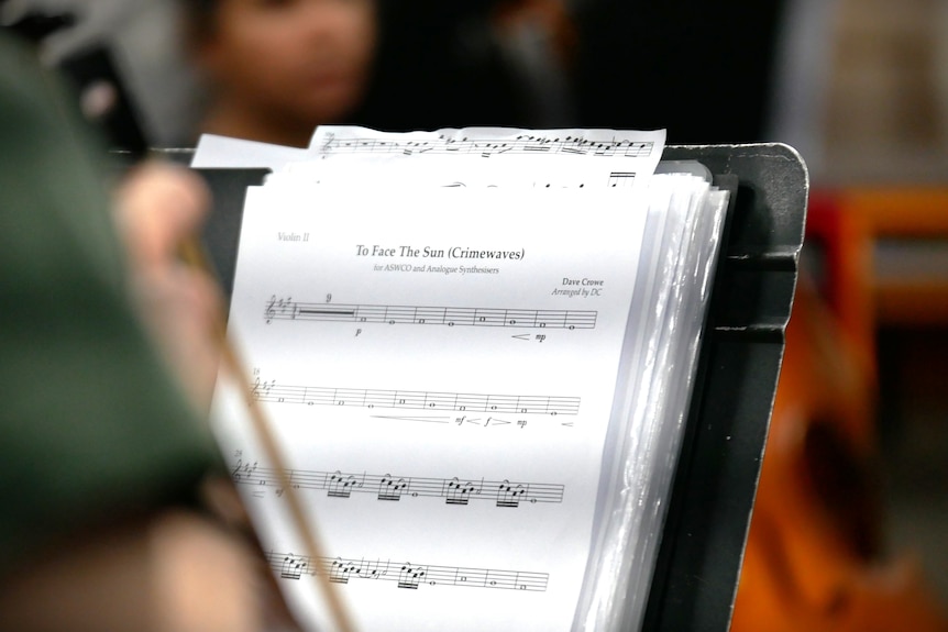 Sheet music is performed by an orchestra