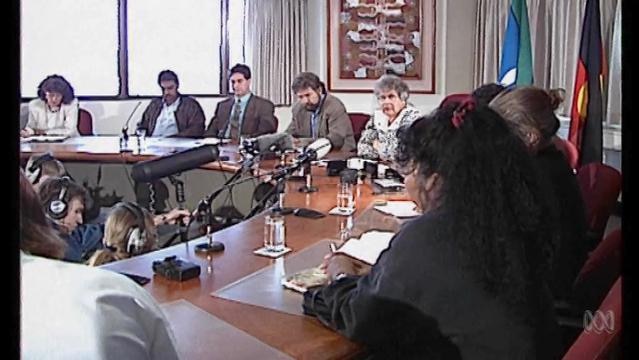 Indigenous leaders sit around table at press conference