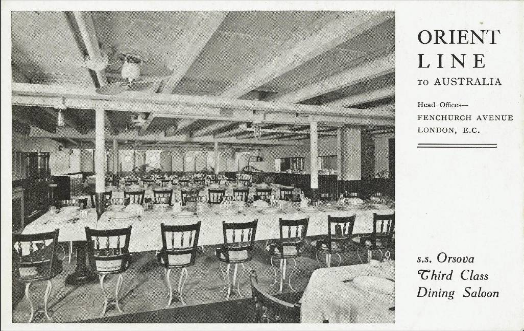 A black and white photo of a dining hall set to seat hundreds of people. 