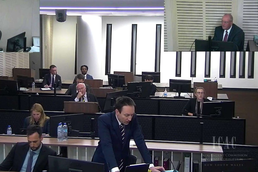 Daryl Maguire gives evidence from the box at the ICAC with other legal types looking on.