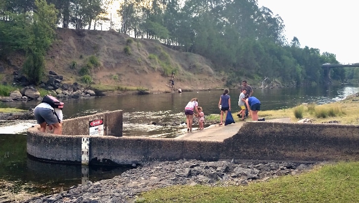 People paddling in the water at the weir.