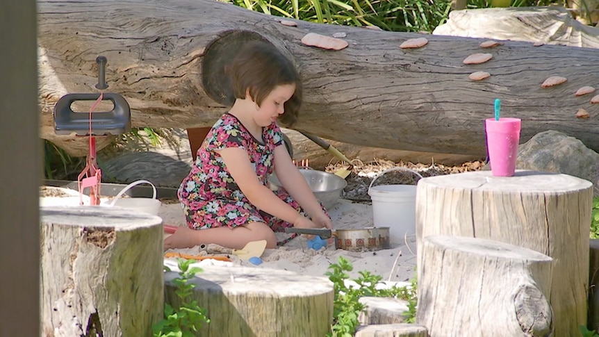 Young girl plays in an Australian landscaped sand pit