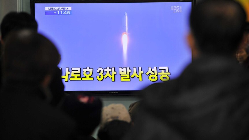 South Koreans watch rocket launch