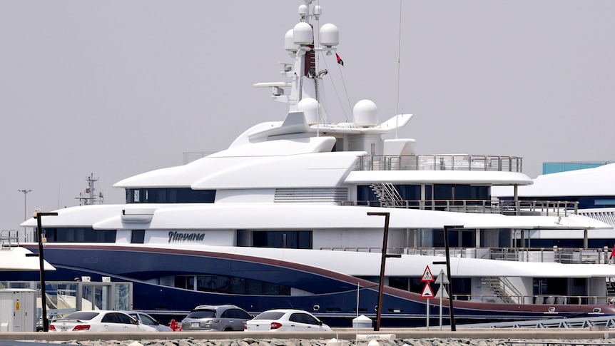 A 88-meter-long superyacht docked with the name "Nirvana" on the front. 
